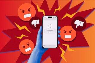 A hand holds a phone that shows a loading screen. Thumbs down and red, angry faces float around the phone.