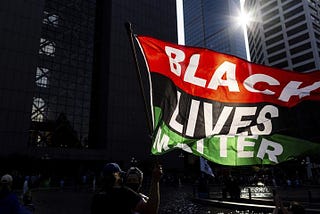 Red, Black, and Green “Black Lives Matter” flag flying in the sun