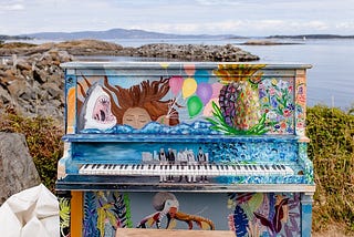 Image of a beautifully colored Piano on a green cliff by the sea