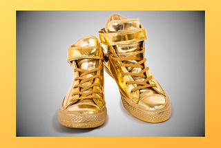 A pair of shimmering, ostentatious high-top sneakers.