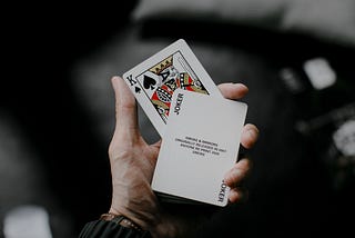 A person holding playing cards.