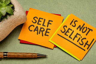 Two yellow stickies saying self-care is not selfish