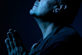 side profile portrait of man looking up with hands in prayer, Lisa Gerard Braun, Medium