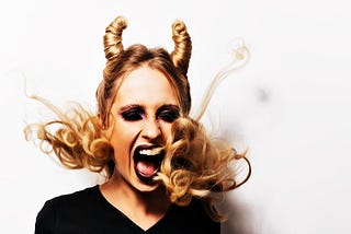 Blonde woman with horns screaming