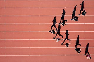 Photo of athletes on a track, running.