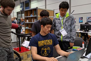 Students programming a robot during the Amazon Picking Challenge, 2016