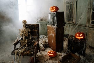 A skeleton sitting in a chair watching tv, in a room covered in spiderwebs.