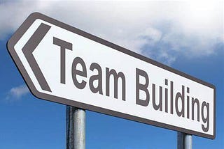 A road sign that reads “Team Building”
