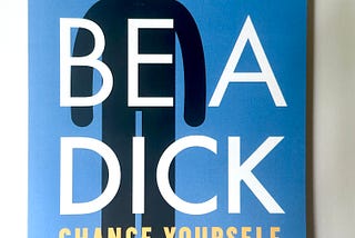 A blue book cover that says, in sans serif typography, “Don’t Be A Dick: Change Yourself, Change Your World” by Mark B. Borg, Jr., PhD. There is a black pictographic figure whose head looks like a bomb behind the typography.