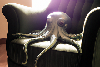 A photograph of Cthulhu sitting in a chair in a sunlit room
