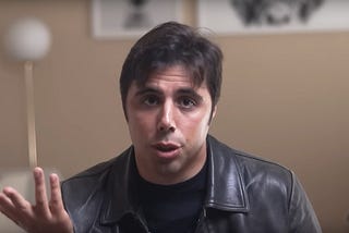 A screenshot of John Mauriello talking to the camera during the video “How Culture Rewires The Brain”