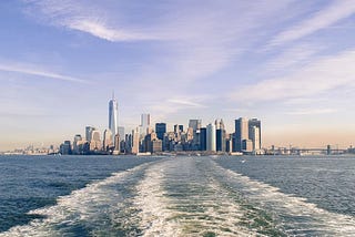 Boat wake showing New York City in the distance