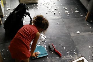 Kid cleaning a messy floor