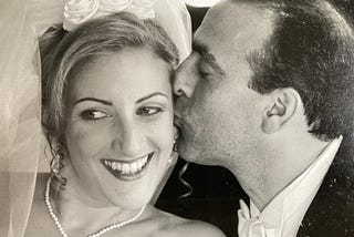 A groom kisses his bride on their wedding day.