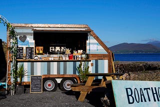 Cromane Boathouse coffee trailer by beach in Reeks District, Ireland