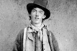 Face picture of Billy the Kid wearing a traditional outfit for the time.