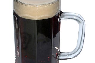 Color photo of a large glass mug of black beer.