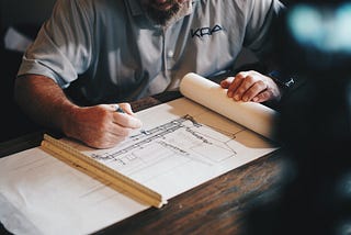 Man drawing blueprint