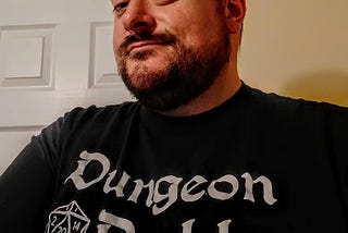 The author wearing a D&D t-shirt that says “Dungeon Daddy.”