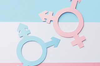 A trans flag background (blue, white and pink) with two trans symbols on top. One in blue and one in pink.