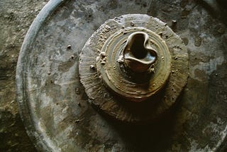 Color photo of a heart-shaped clay creation on a potter’s wheel.