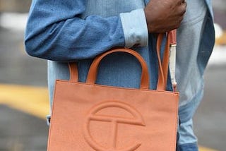 A shopper with a brown Telfar shopping bag