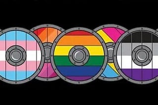 A set of ten Viking shields arranged in a horizontal, overlapping shield wall are decorated with various pride flag colours, including the standard rainbow pride flag colours, the transgender/gender diverse colours and the asexuality flag colours
