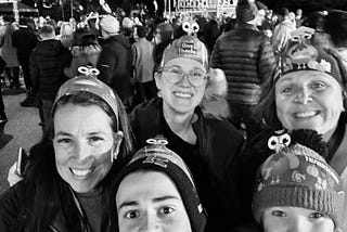 Three friends with two of thier children at the Macy’s Thanksgiving Baloon Blow-up event, standing in front of Tom Turkey, wearing turkey headbands.