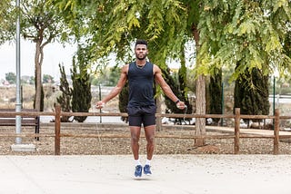 A man exercising with a jumping rope; one action he takes to change his life for the better.