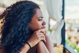 Black woman looking off in distance