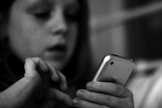 Young girl dialing a cell phone