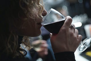 Woman drinking a glass of Merlot.