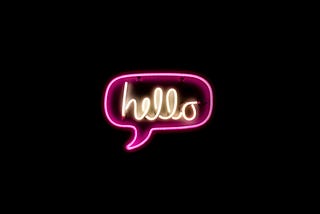 The word “hello” in a speech bubble in neon.