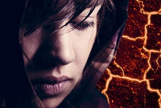 a sad young woman’s face against a background of a reddish brown surface with cracks of light breaking through it.