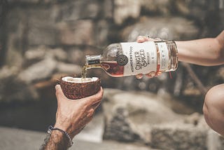 Pouring whiskey in a open coconut, meaning I need a break.