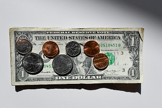 Screenshot of a dollar bill plus coins