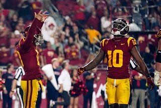 USC quarterback Caleb Williams and Wide Receiver Kyron Hudson are celebrating a touchdown.