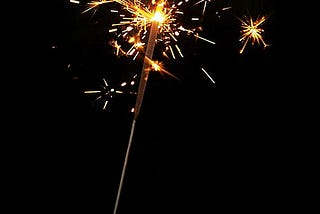 Hand holding a lit sparkler