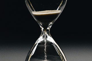 Sands fall through an hourglass