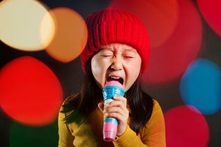 A little girl singing like a rock star