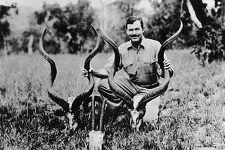 Black-and-white photo of a young Ernest Hemingway in Africa in 1934