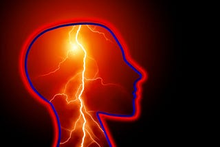 A picture of a head outlined in red showing red lightning inside the head running down the neck where the image cuts off.