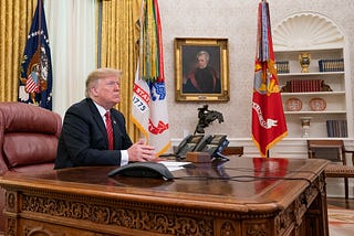 Donald Trump sitting at White House desk reading fan mail