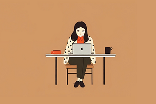 A designer working on her computer while sitting at the desk with a cup of coffee.