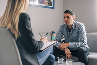 Man meeting with a counselor.