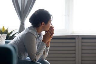 Young woman looking out the window.