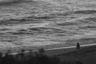 A lone figure at sea