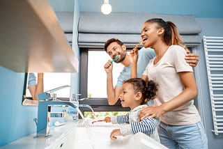 Whole Family Doing Burshing and Represent the Oral/ Dental Health