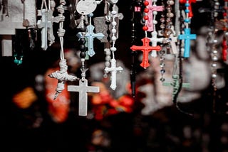 A collection of plastic rosaries hanging down.