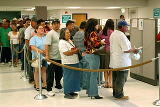 Large group of people wait in line to get assistance with the California EDD claim.